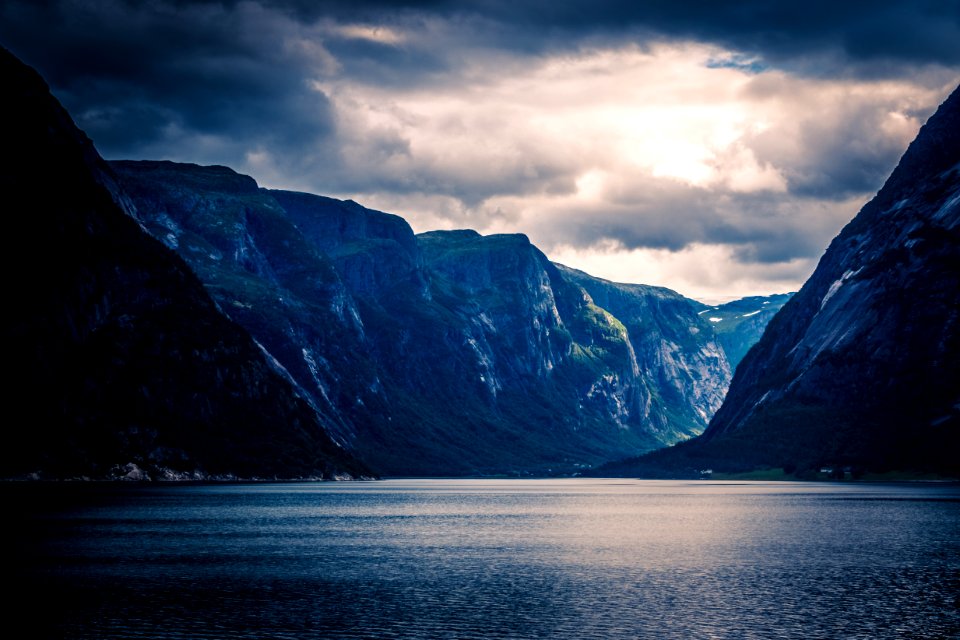 Ocean Near Mountain Ranges During Sunset photo