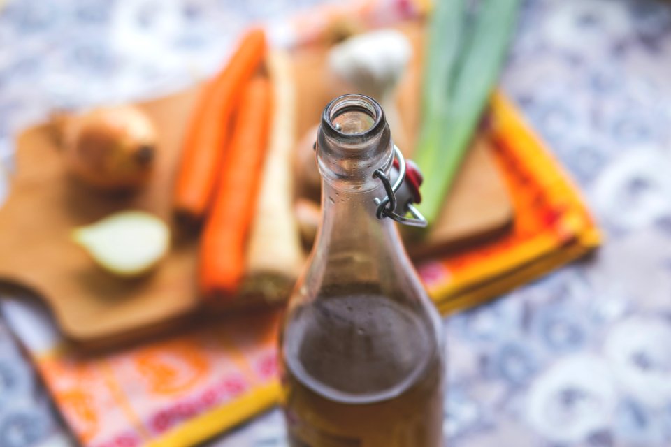 Clear Glass Bottle With Brown Liquid In Selective Focus Photography photo