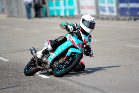 Biker Riding A Teal Sport Bike