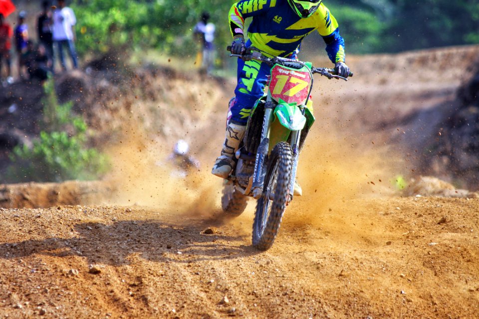 Man Riding Green Dirt Motorcycle During Daytime