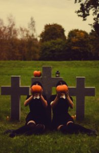 People With Pumpkins On Graveyard