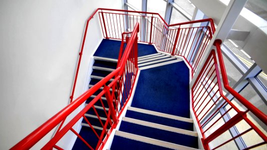 Blue Stairs And Red Handled On White Paint Wall