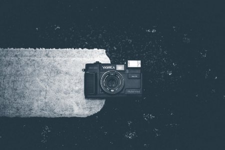 Blakc Camera On White Textile photo