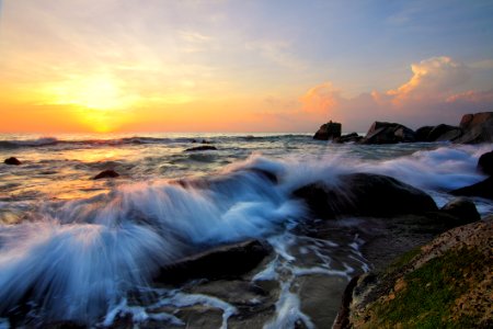 Waves On Rocky Shores At Sunrise photo