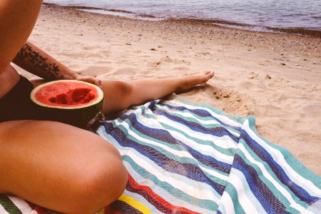 Woman Eating Watermelon On Beach photo