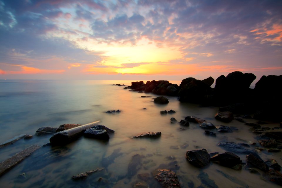 Black Rock Formation On The Sea During Sunset