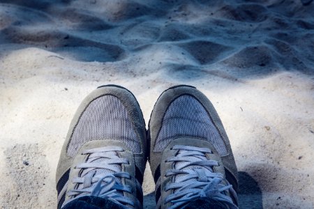 Grey Shoes On Top Of Grey Sand photo