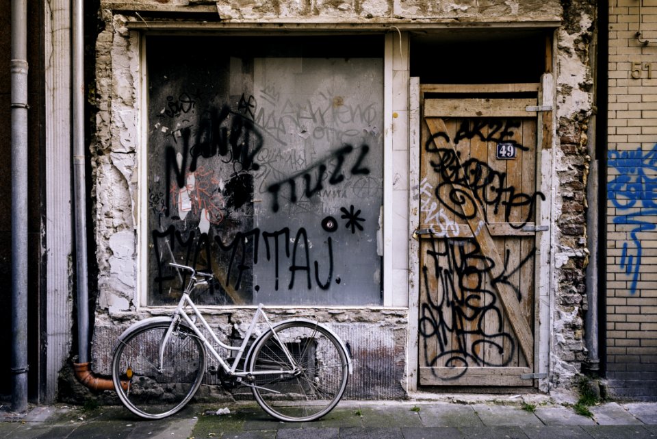 White Cruiser Bicycle Parked In Front Of White Concrete House