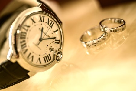 Silver Wedding Rings Near Silver Round Analog Watch photo