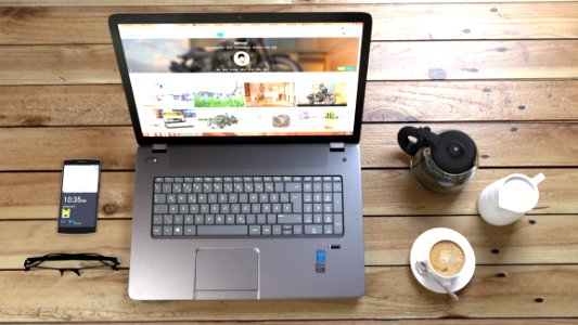 Silver Laptop Next To Coffe Cup Smartphone And Glasses photo