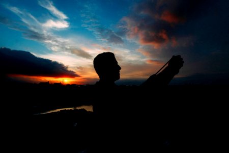 Man Taking Selfie At Sunset