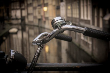 Black And Gray Bicycle Handle Bar With Bell Near Canal photo