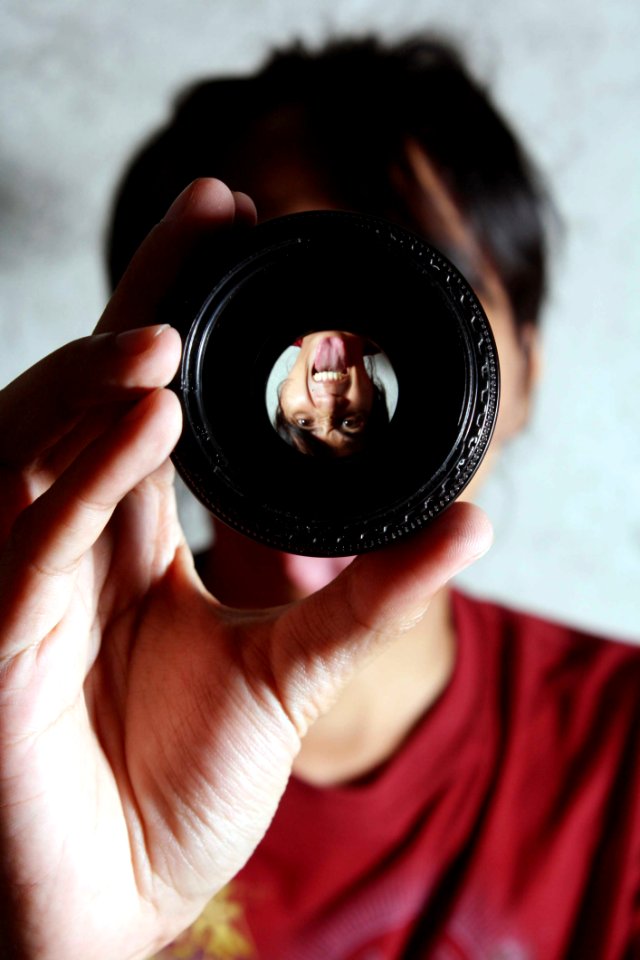 Woman In Red Crew Neck Shirt Holding A Black Round Palette photo