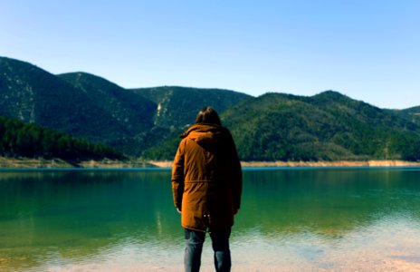 Man Looking Across A Lake photo