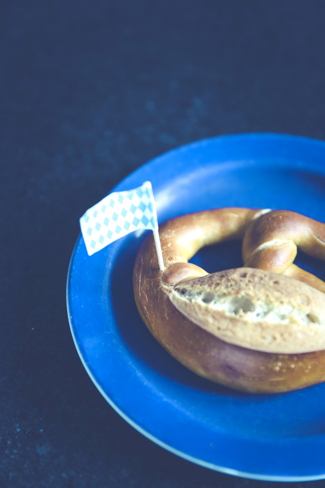 White And Blue Plastic Flag On Pastry On Blue Plastic Plate