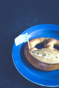 White And Blue Plastic Flag On Pastry On Blue Plastic Plate