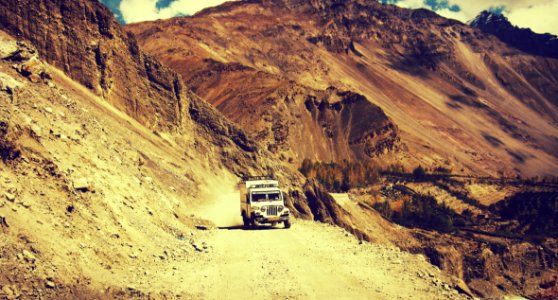 White Truck Riding On Brown Sandy Surface During Daytime