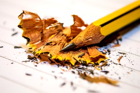 Yellow Black Pencil Sharpened Above The White Paper In Macro Photography photo