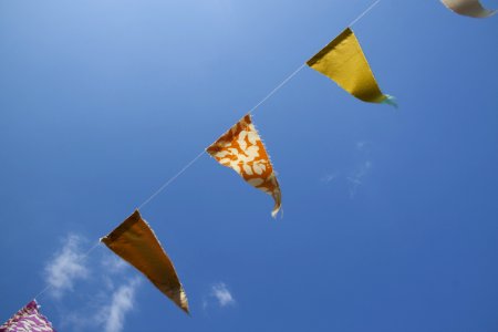 Orange Yellow And Red Flaglets Under Blue White Sky During Daytime