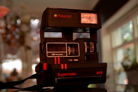 Black Polaroid Supercolor Camera On Black Table photo