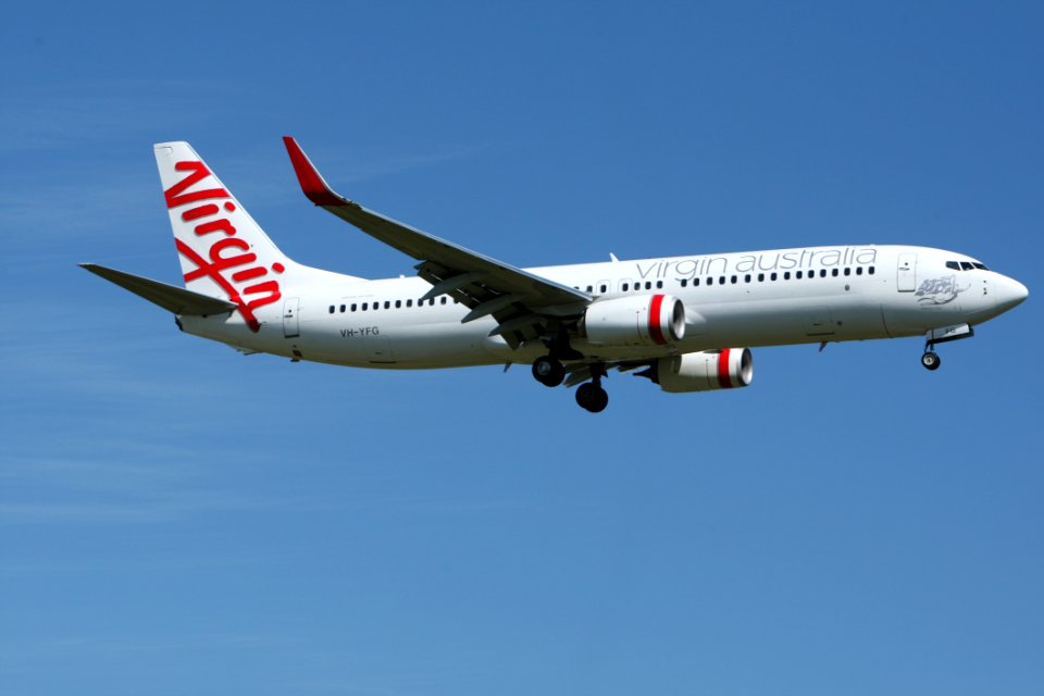 White And Red Virgin Australia Airplane Mid Air Under Blue And White Sky During Daytime
