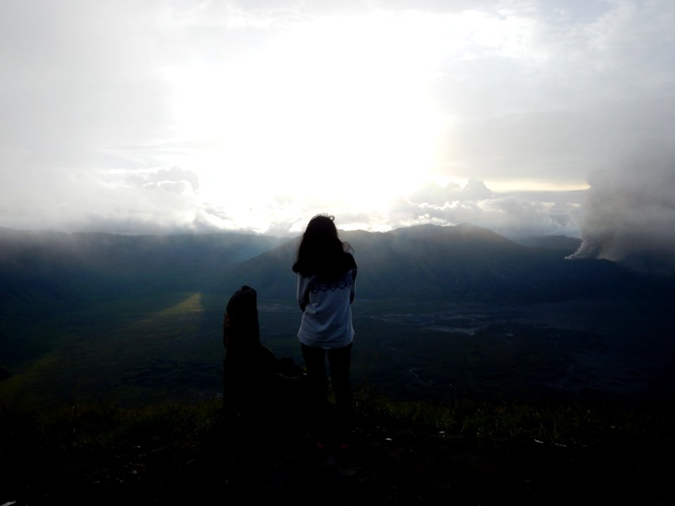 Woman Staing At The Edge Of The Mountain Facing The Sun