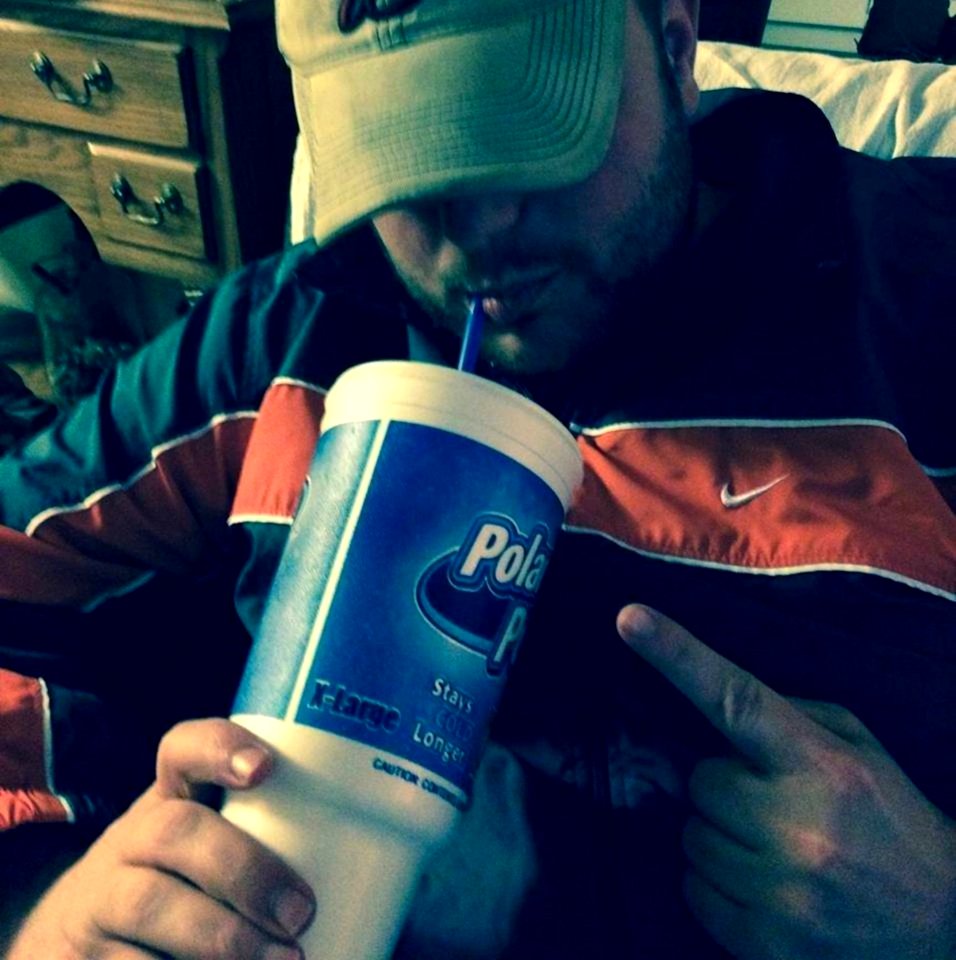 Man Drinking Fizzy Drink Through Straw
