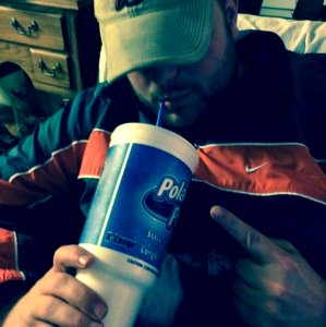 Man Drinking Fizzy Drink Through Straw photo