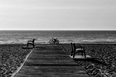 Grayscale Photo Of Bicycle Beside Seashore photo