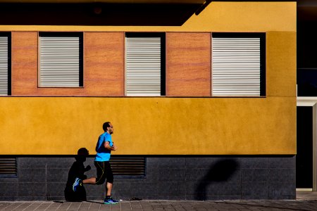 Jogging Man Wearing Blue Shirt During Daytime photo
