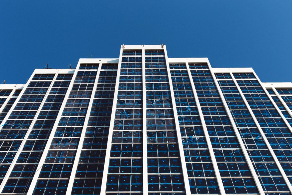White And Blue High Rise Building Under Blue Sky During Daytime photo