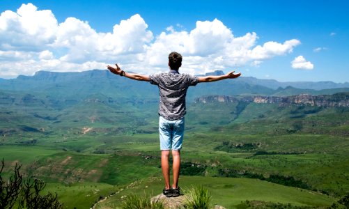 Man Wearing Grey Shirt Standing On Elevated Surface photo