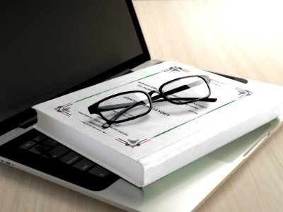 Black Frame Eyeglasses On White Book photo