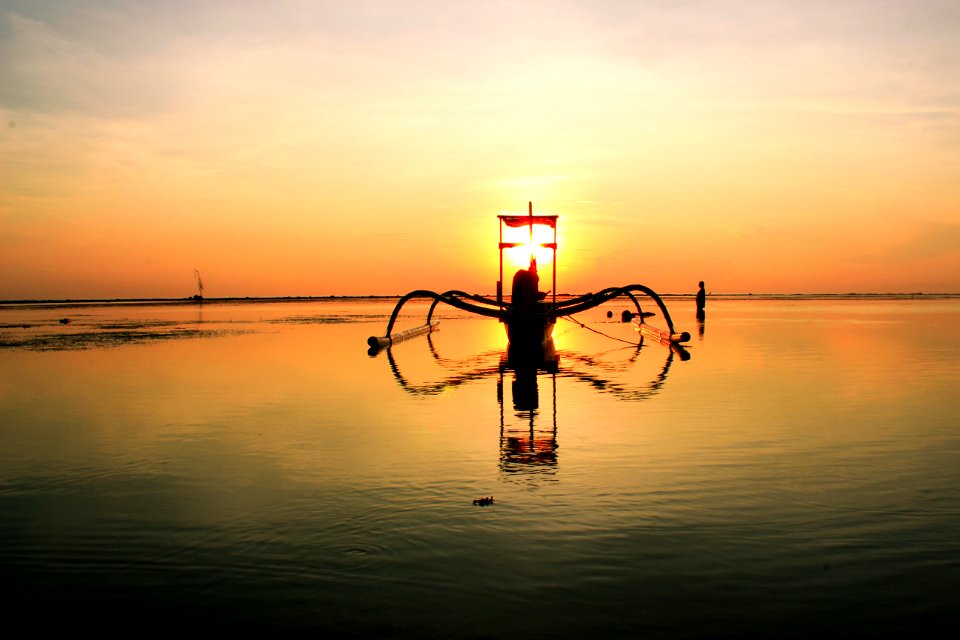 Sailboat On Clear Calm Sea Floating During Sunset