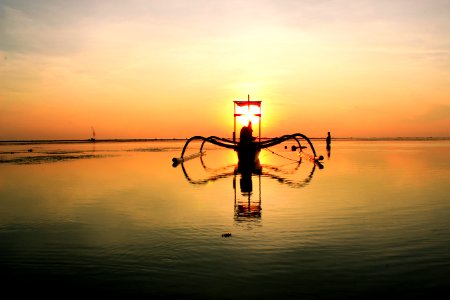 Sailboat On Clear Calm Sea Floating During Sunset