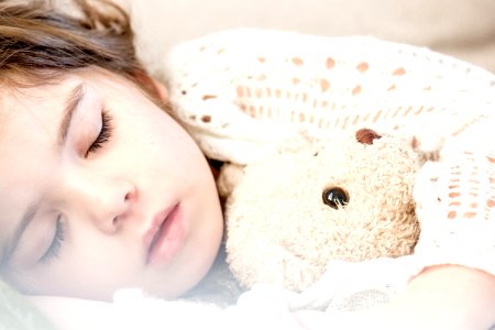 Girl Sleeping With Her Brown Plush Toy photo