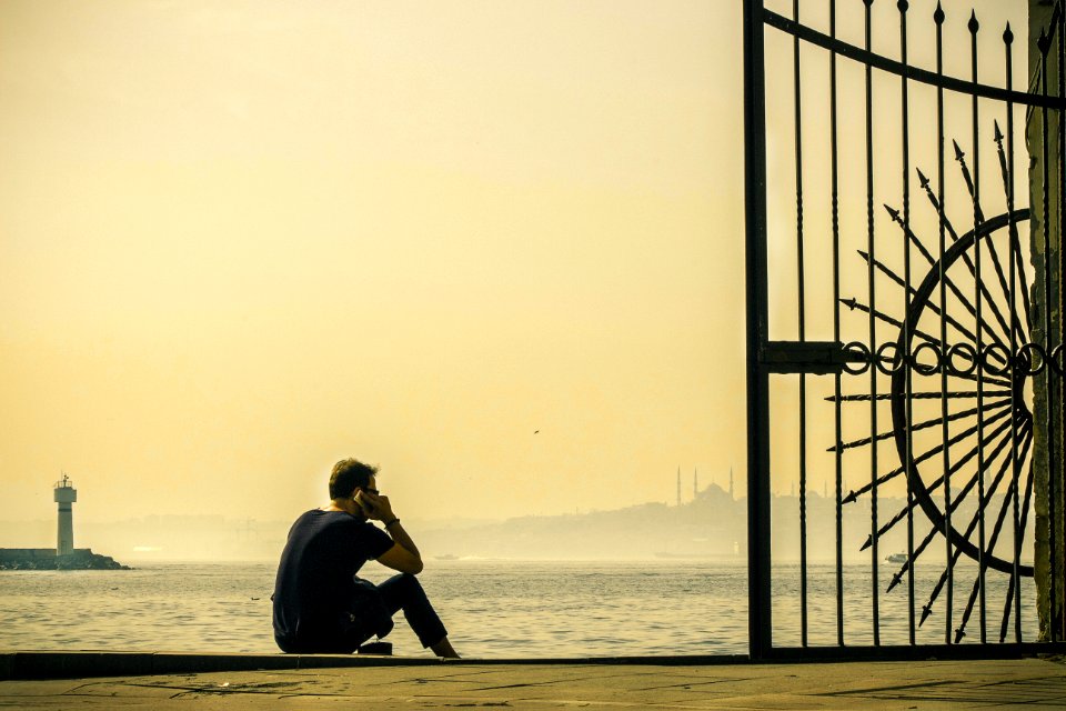 Man Sitting At Harbor