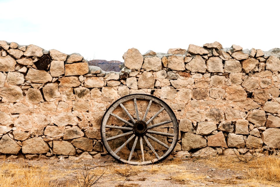Wagon wheel against a stone fence at Hueco Tanks State Park, northwest of El Paso, USA. Original image from Carol M. Highsmith’s America, Library of Congress collection.