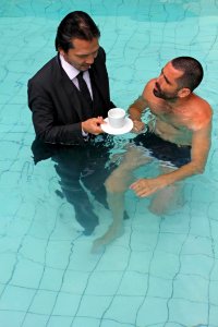 Man In Business Suit With Coffee In Swimming Pool