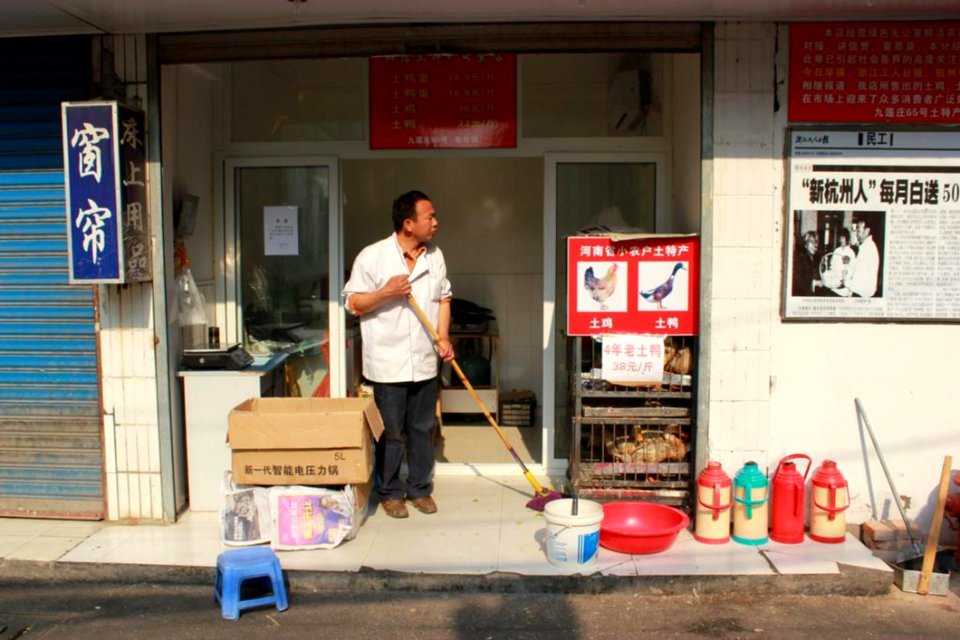Shopkeeper Sweeping Storefront