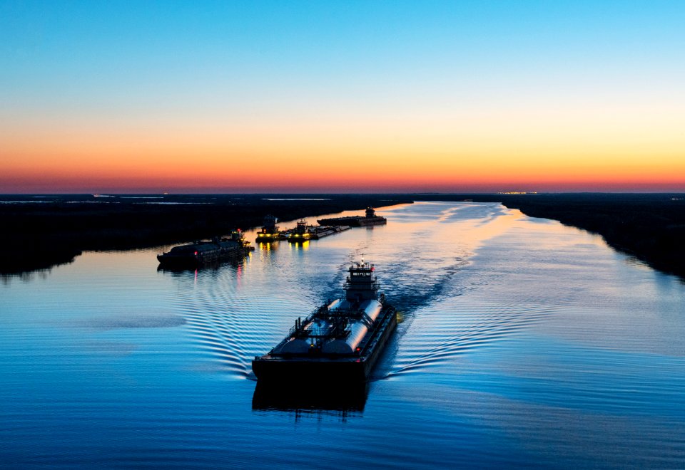 Dusk shot of barges traversing a short canal that connects the Sabine Pass waterway separating Texas from Louisians, and the Trinity River, south of Port Arthur, Texas. Original image from Carol M. Highsmith’s America, Library of Congress collection.