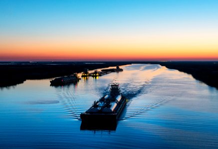 Dusk shot of barges traversing a short canal that connects the Sabine Pass waterway separating Texas from Louisians, and the Trinity River, south of Port Arthur, Texas. Original image from Carol M. Highsmith’s America, Library of Congress collection. photo