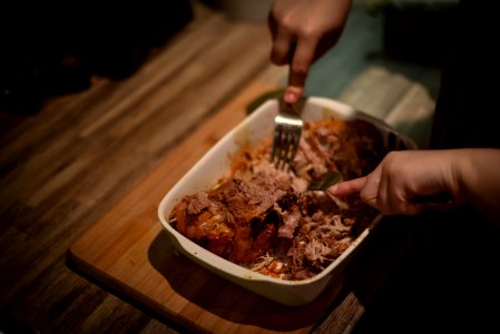 Person Mixing Cook Meat On White Food Container photo