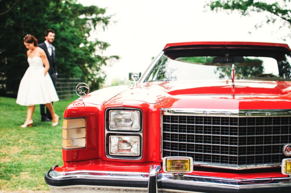 Couple Standing Near Red Classic Monte Carlo