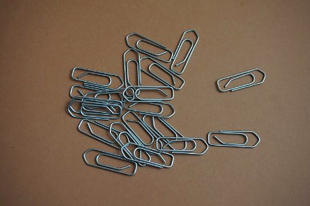 Gray Paper Clip On Brown Table photo