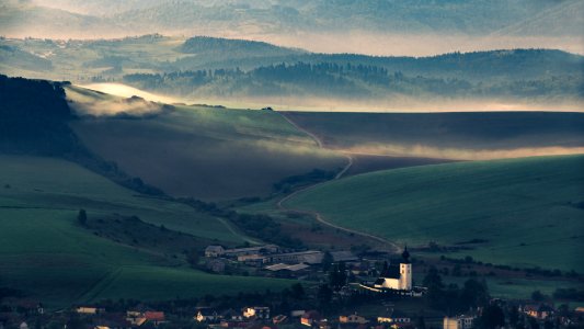 Village In Valley At Sunset