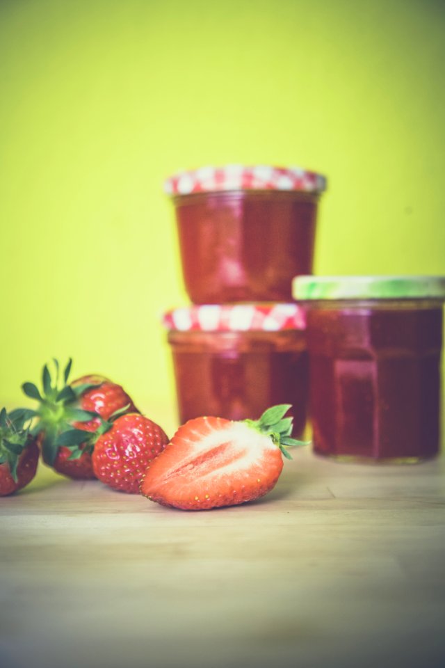 Strawberry Near Red Jar On Wooden Surface