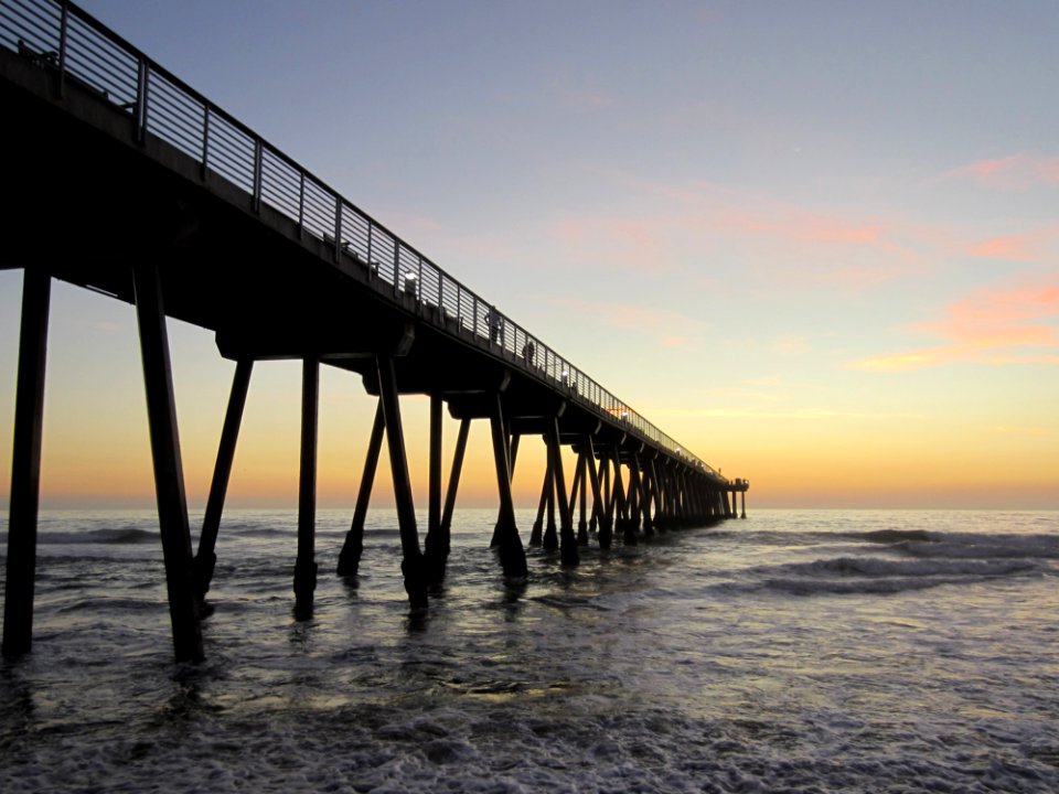Pier In Water At Sunrise