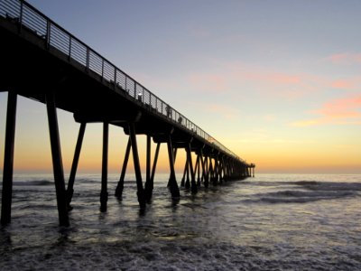 Pier In Water At Sunrise photo