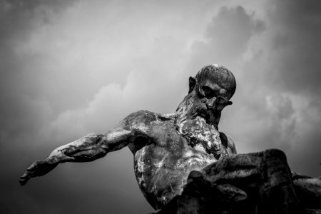 Grayscale Photo Of Gray Man Statue